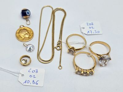 a lot of gold rings and other jewelry on a table