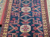 three rugs are laid out on a wooden floor in a room