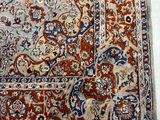 an oriental rug on a white floor with a red and blue border