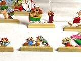 seven figurines of different characters displayed on a table