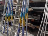 many ladders that are stacked on top of each other in a warehouse