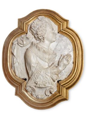 an image of a white marble plaque with a woman holding a child