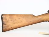 an old rifle with a wooden barrel on a white background