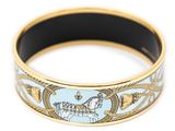 a close up of a gold and blue bracelet on a white background
