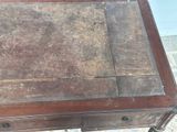 a small wooden table with a drawer on top of it