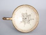 a white and gold plate with a clock on it