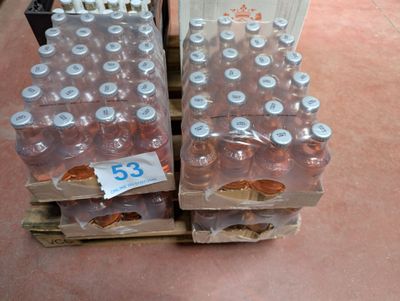 several bottles of water are stacked on a pallet with a price tag