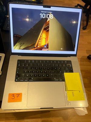 a laptop computer sitting on top of a wooden table
