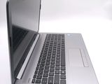 a silver laptop with a black keyboard on a white surface