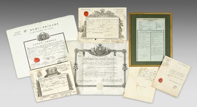 a group of old papers and other items sitting on top of a table