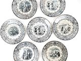 six black and white plates with pictures of people and animals on them