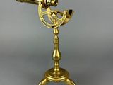 an antique brass telescope on a tripod stand