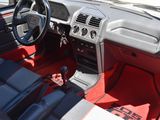 a red and black interior of a car that is parked in a lot