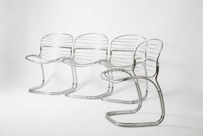 quatre chaises sont alignées en rangée sur un fond blanc