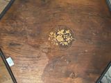 a small wooden table with a decorative design on it
