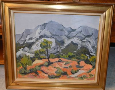 une photo d'un tableau représentant des montagnes, dans un cadre doré