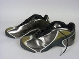 silver and black running shoes with black laces on a white surface