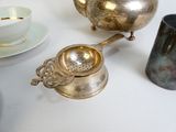 a silver tea pot and a silver teapot on a table