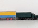 several toy trucks are lined up in a row on a white surface