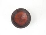 a small brown object on a white surface