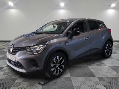 a grey car is parked on a checkered floor in a showroom