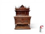 a wooden cabinet with carvings on the top of it