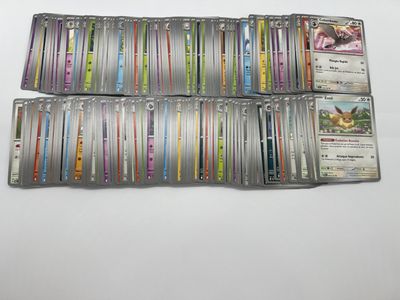 a bunch of pokemon cards sitting on top of each other