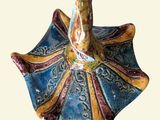 a blue and yellow umbrella shaped object on a white background