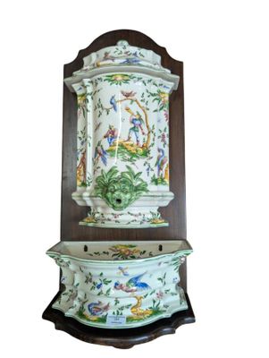 a clock that is on the wall with a bird on it
