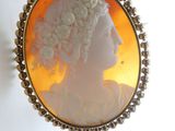 a picture of a woman ' s profile in a broochle
