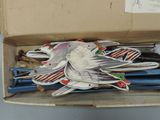a cardboard box with a bunch of wooden birds in it