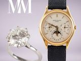 une image représentant une montre en or et une bague en diamant sur laquelle figurent les lettres « wwi »
