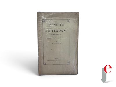 an old book sitting on top of a white table next to a red and white logo