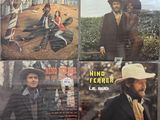four lps of various music from the 1970s ' s including a man in a cowboy hat, a woman in a dress and a man in a cowboy hat