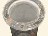 a silver vase that is sitting on top of a table