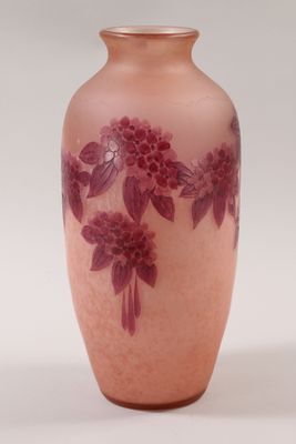 a pink vase with purple flowers on it on a white background