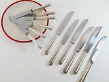 a plate with knives and a knife sharper on it