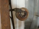 a close up of a door handle on a wooden door