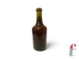 a brown bottle with a brown cap sitting on a white surface
