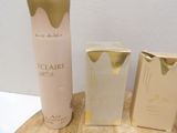 a bottle of eclaire and two boxes of perfume