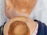 a doll with a brown spot on it ' s back