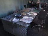 a desk with a chair and a laptop on it in a room