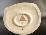 a close up of a white plate with a triangle on it