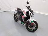a picture of a white and green motorcycle parked in a room