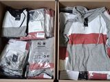 boxes of clothing are packed in a cardboard box on a table