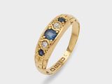 a gold ring with sapphire and diamonds