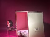 pink room with a bed and a chair with a pink light on it