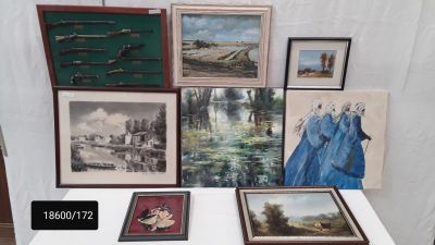 a table that has a bunch of paintings on it