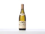 the bottle of wine is sitting on the table on a white surface
