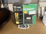 a box of radio sitting on a shelf next to a guitar